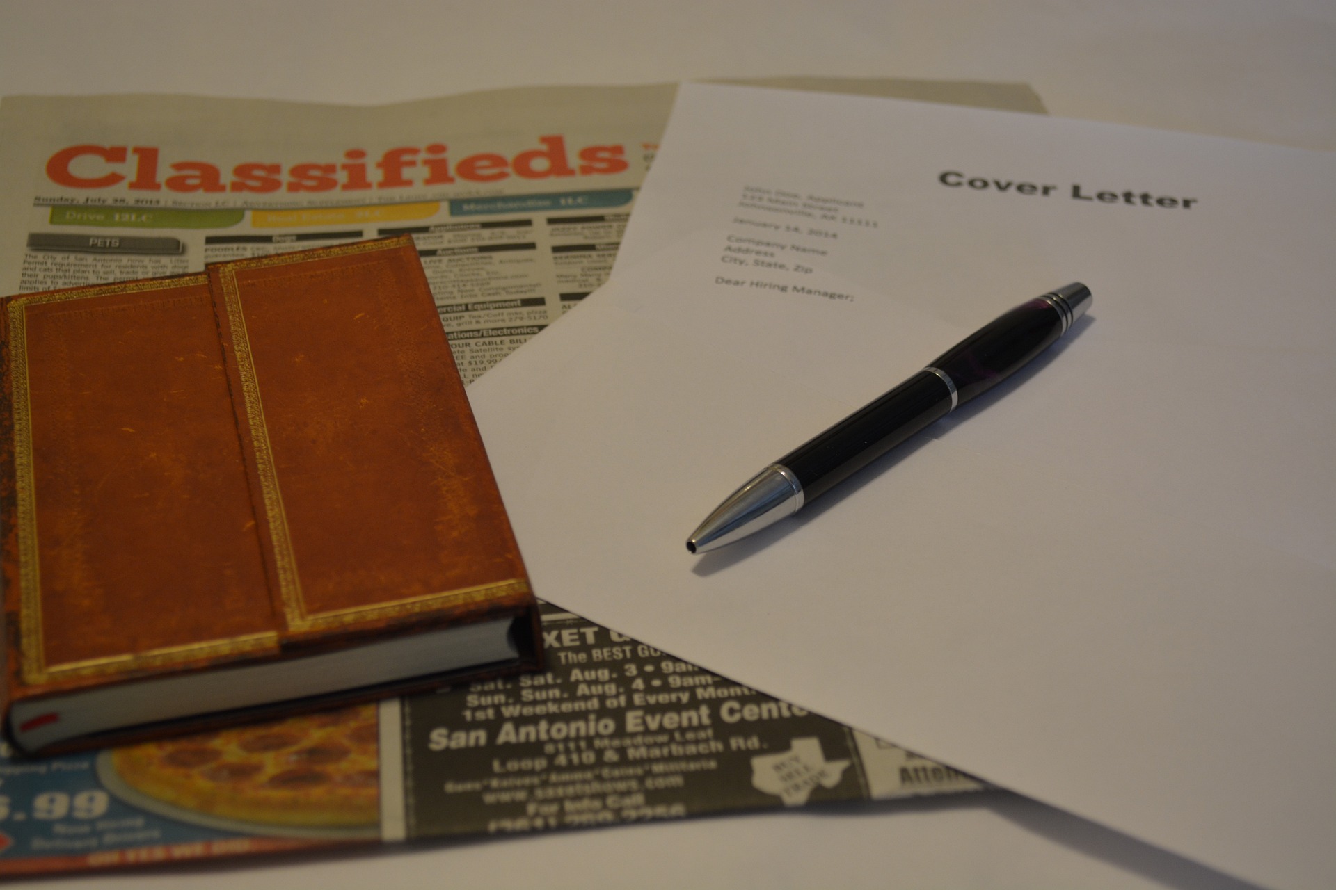 Photo of newspaper, notebook, pen and cover