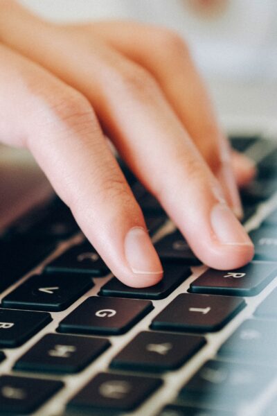 Fingers touching a computer keyboard