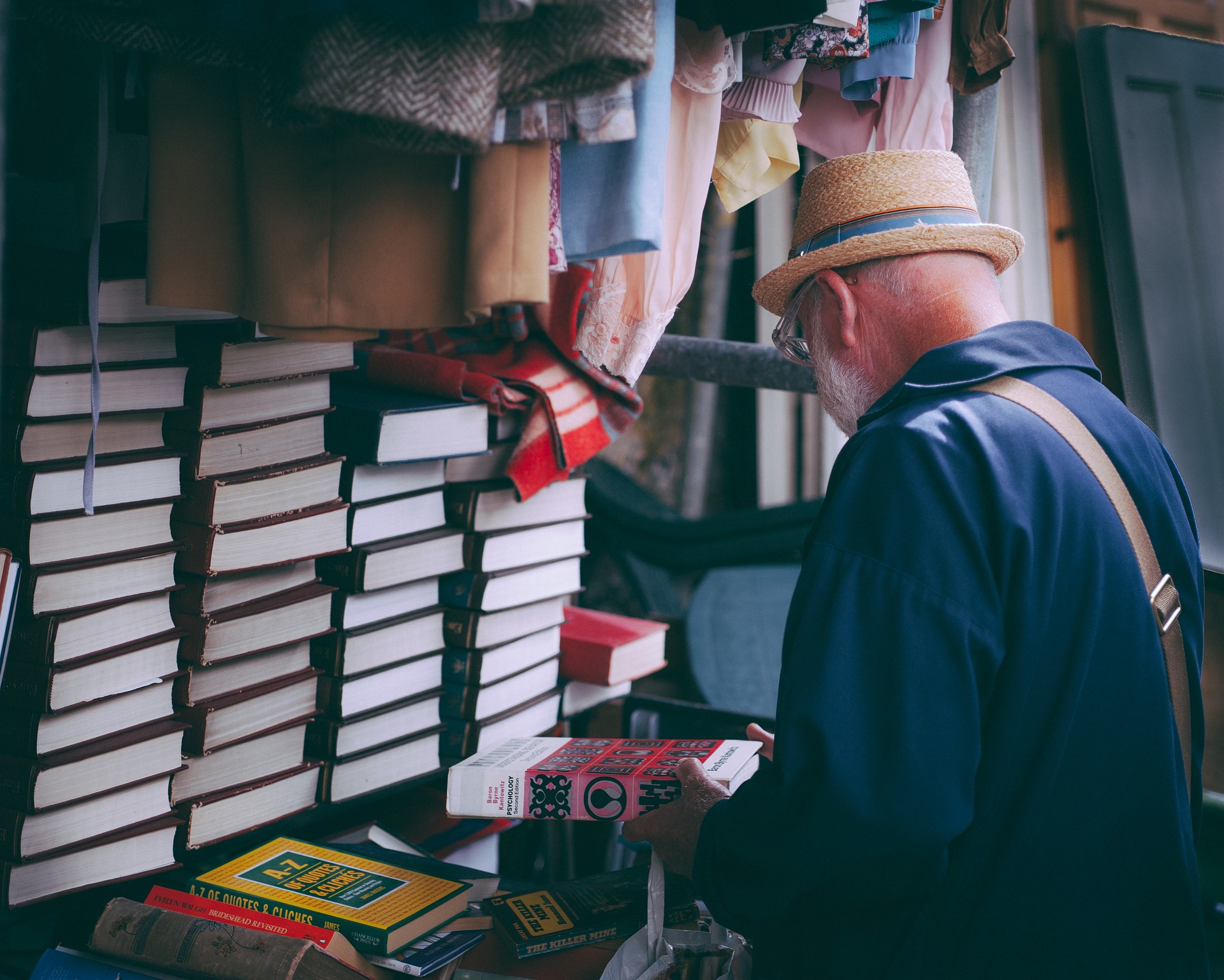 Photo of a man wearing glasses shopping for books