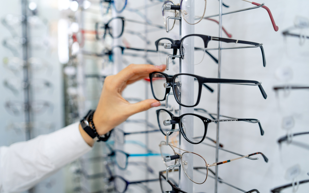Person selecting eyeglasses