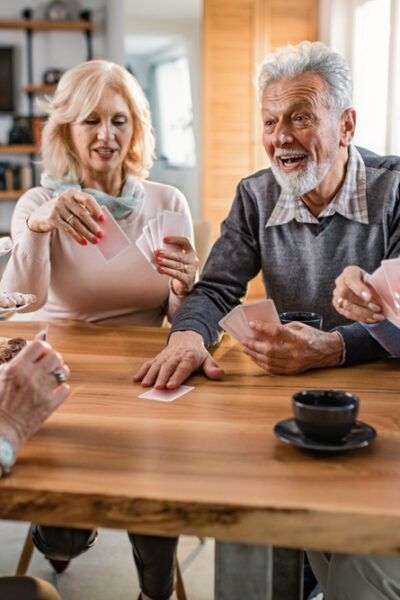 group of older adults play cards