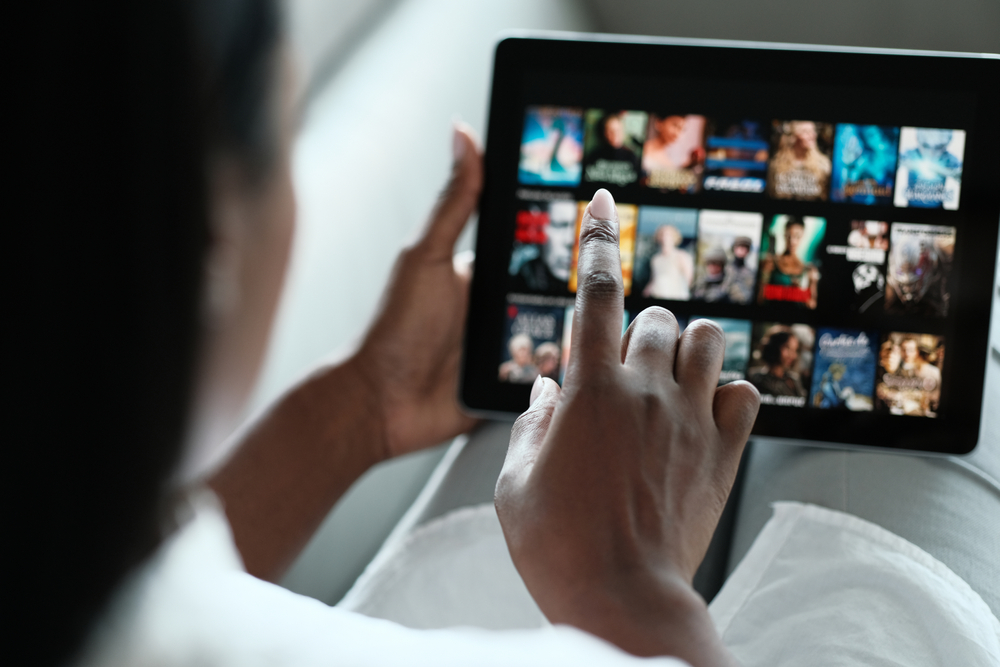 Person using an ipad to choose a streaming show