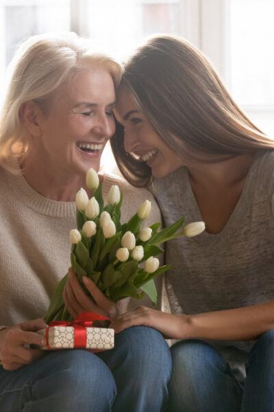 Older adult receives flowers and a gift