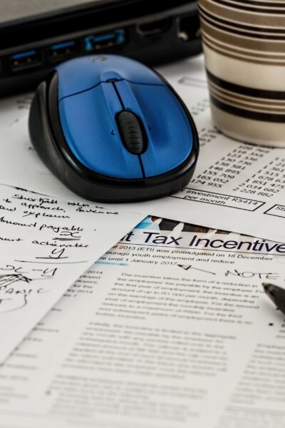 Tax documents and handwritten notes spread across a table